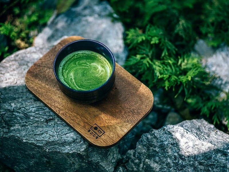 photo of matcha drink on a wooden tray