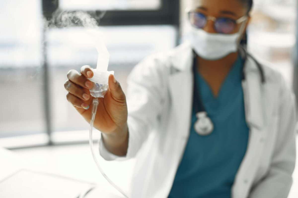 close up photo of a healthcare professional holding a nebulizer