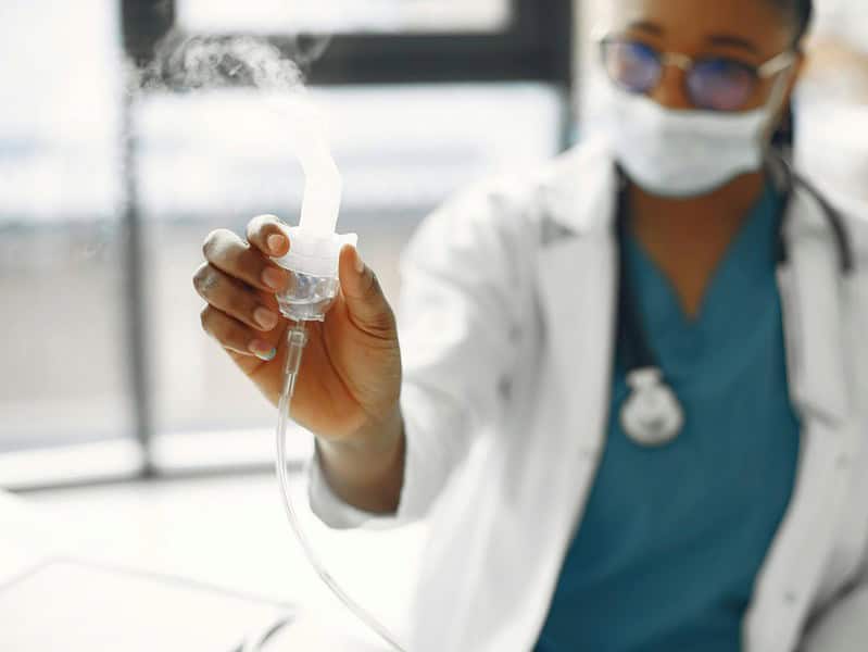 close up photo of a healthcare professional holding a nebulizer