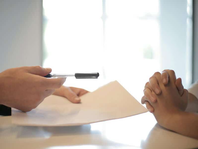 crop businessman giving contract to woman to sign